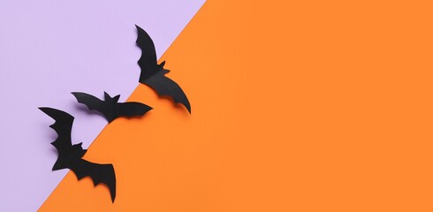 Fototapeta premium Paper bats for Halloween party on colorful background with space for text