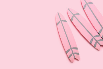 Mini surfboards on pink background