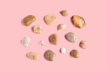 Many pebble stones on pink background