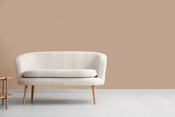 Cozy white sofa near beige wall
