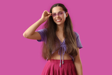 Stylish young woman on purple background