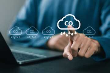Businessman using laptop with reduce CO2 emissions carbon symbol for climate change to limit global warming and sustainable development and green business concept