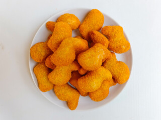 Delicious chicken nuggets in a plate, isolated white background