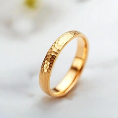 Hammered gold ring with a textured finish, adding a rustic elegance
