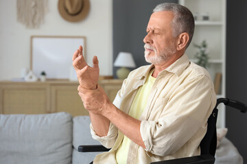 Senior man suffering from Parkinson syndrome in wheelchair at home