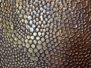 Close up random round circle texture forming bee honey comb pattern on top of antique metal surface. Many circles forming trypophobia, fear of circle or round shape pattern or holes.