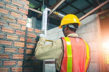 The engineer inspects the site amidst a growing structure.