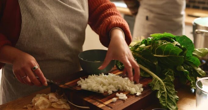 Hands, couple and cooking in kitchen with meal prep, healthy dinner and vegetable ingredients. People, food and fresh produce with onions, spinach and vegan recipe for nutrition, wellness and lunch