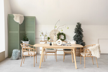 Interior of dining room with festive table setting and Christmas decorations