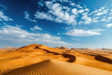 Dry season desert landscape with rolling dunes and a brilliant blue sky overhead