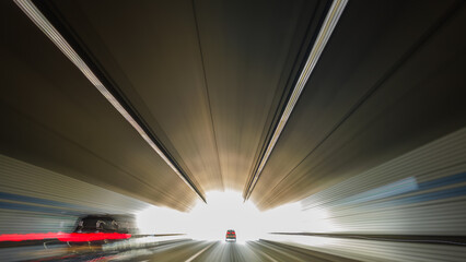 Obraz premium This is a long exposure motion blur image of the light trail going out of the tunnel.