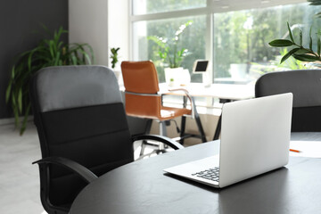 Laptop on table in modern office, closeup