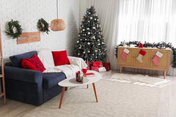 Interior of living room with Christmas tree, grey sofa and festive decorations