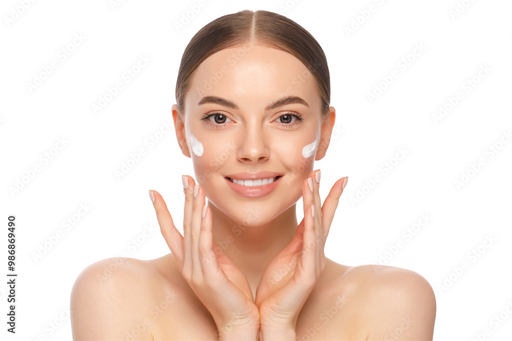 Wall mural young beautiful woman with clear skin applying face cream with fingers