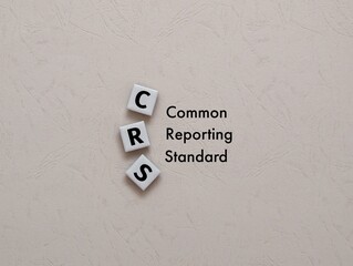 square magnet with the letters CRS for the word Common Reporting Standard. the latest report on the need for information collection in business institutions