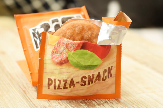 Editorial illustrative image of backed filled bread or pizza snack. 