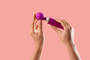 Woman with vibrator and lubricant on pink background