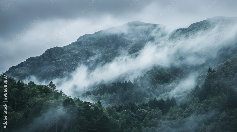 Poster a mysterious mountain range shrouded in fog and mist, creating a dramatic and atmospheric scene.