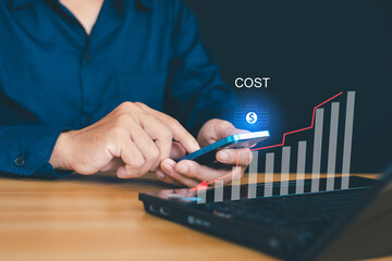 Cost management concept. Businessman working to save company's cost. The word 'COST' appears as a...