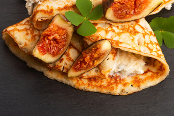 Crepes or thin pancakes with gorgonzola cheese, honey and figs fruits