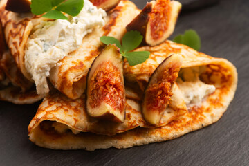 Crepes or thin pancakes with gorgonzola cheese, honey and figs fruits