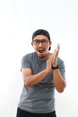 Naklejka premium Young handsome asian man with beard wearing casual shirt and glasses over white background clapping and applauding happy and joyful, smiling proud hands together