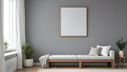 A minimalist living room with a gray wall, a wooden bench with white cushions, and a white frame on the wall.