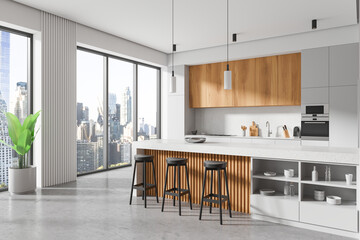 White home kitchen interior with island and cooking cabinet, panoramic window