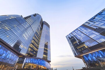Naklejka premium Two modern skyscrapers, both with a predominantly glass facade