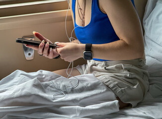 A girl is lying with a phone on a train