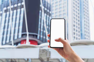 Hand holding smartphone mockup of blank screen, Take your screen to put on advertising.
