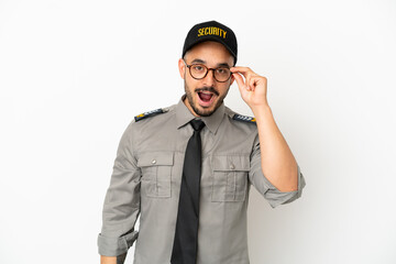 Young security  caucasian man isolated on white background with glasses and surprised