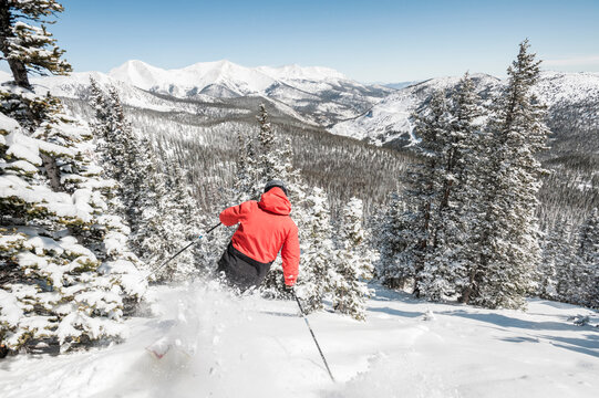 Skier at Monarch Mountain resort skiing powder