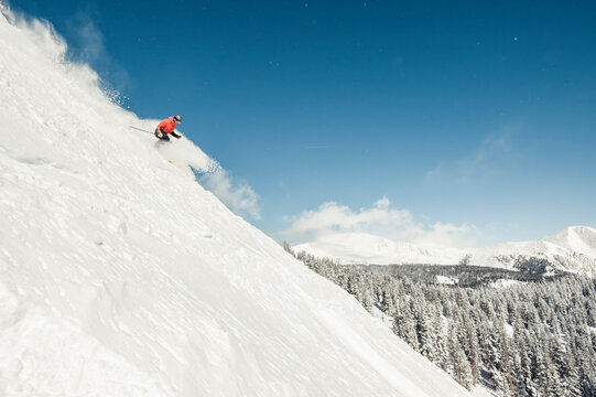 Skier at Monarch Mountain resort skiing powder