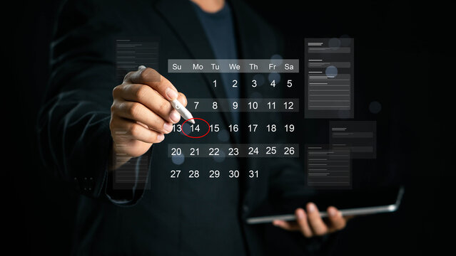 Time management concept. Businessman manages time for effective work. Calendar on the virtual screen interface. Highlight appointment reminders and meeting agenda on the calendar.