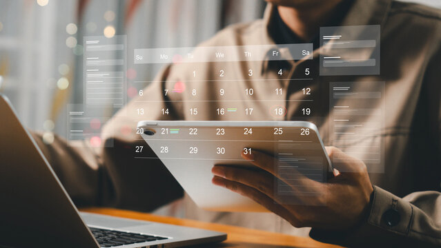 Time management concept. Businessman manages time for effective work. Calendar on the virtual screen interface. Highlight appointment reminders and meeting agenda on the calendar.