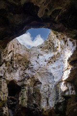 View of the sky from inside the grotto through an opening in the cliff, Polignano a Mare, Italy, Apulia