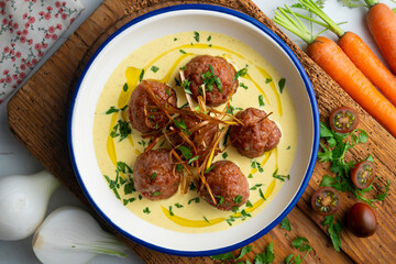 Fried meatballs with curry sauce. Top view table with  decoration.