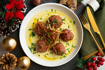Fried meatballs with curry sauce. Top view table with christmas decoration.