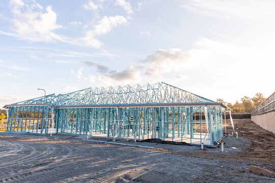 steel frame of a house under construction in the afternoon light