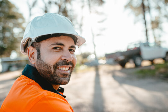 Closeup of a construction worker sitting on the ground of the construction site.