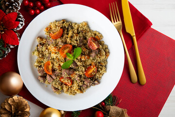 Couscous with beef and vegetables. Top view table with Christmas decoration.