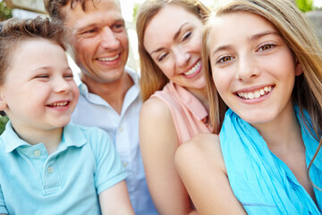 Obraz premium Portrait, children and bonding with family, outdoor and parents with siblings, embrace or love in nature. Happy, woman and man with kids, together and relax in weekend, fun and break in park or youth