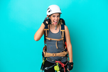 Young Italian rock-climber woman isolated on blue background making phone gesture. Call me back sign