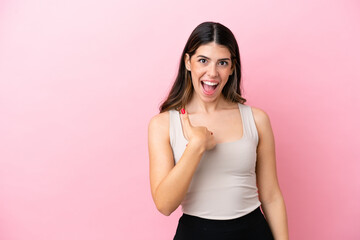 Young Italian woman isolated on pink background with surprise facial expression