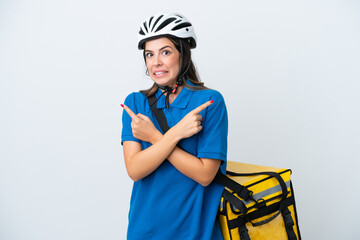 Young delivery woman with thermal backpack isolated on white background pointing to the laterals having doubts