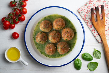 Fish meatballs with green parsley sauce. Top view table with  decoration.