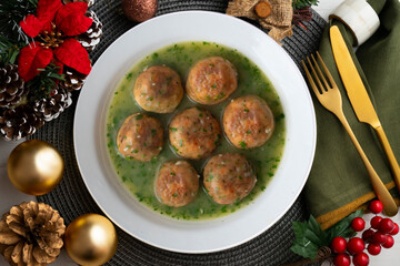 Fish meatballs with green parsley sauce. Top view table with Christmas decoration.