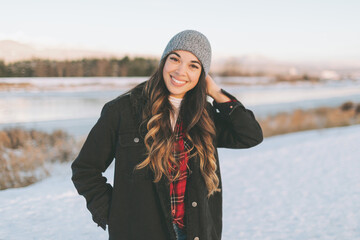 A young woman smiling on a cold winter day. 