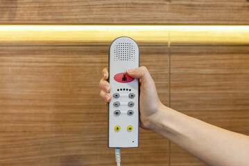 Nurse call button in patient room in modern hospital. Hand pushing nurse call button. patient press...